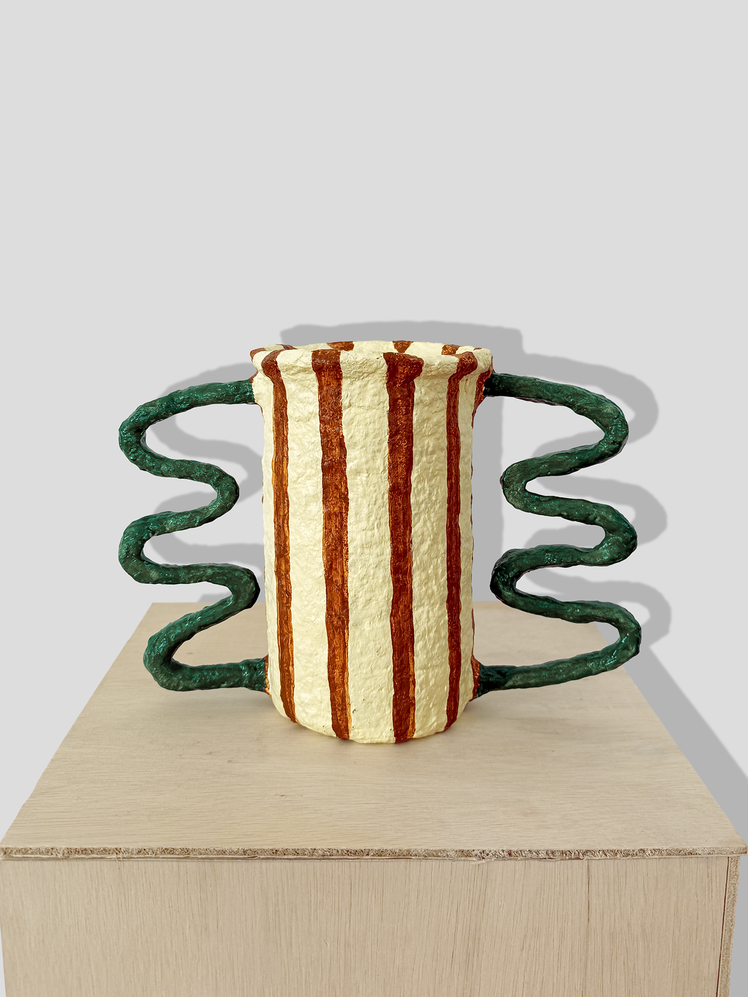 Papier mâché vessel with stripes and irregular handles