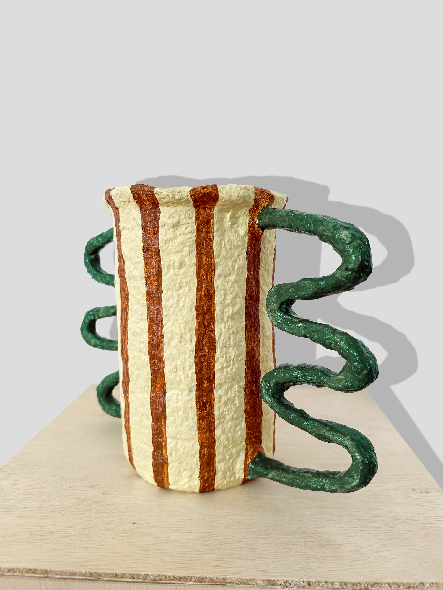 Papier mâché vessel with stripes and irregular handles