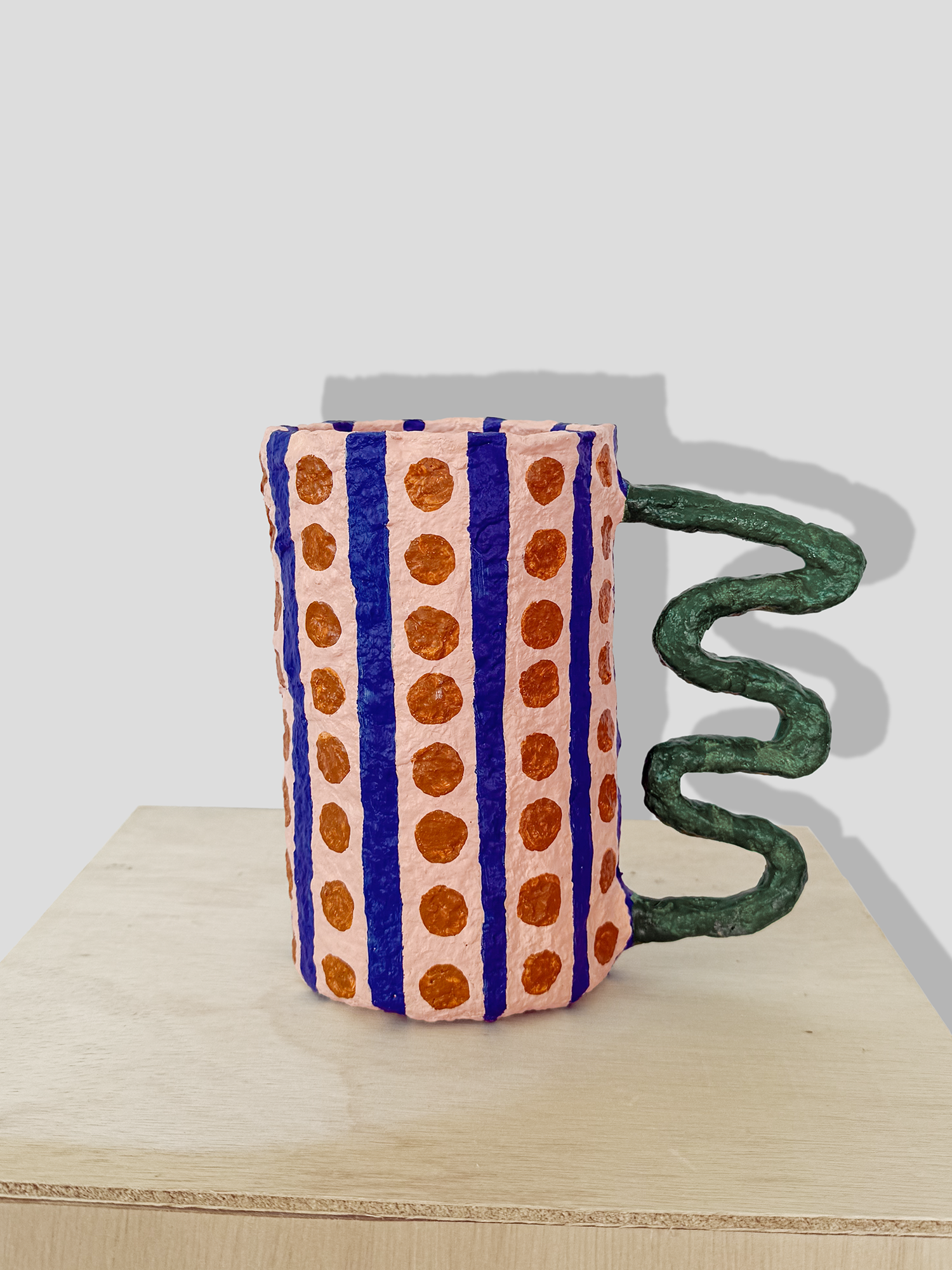 Papier mâché vase with stripes and irregular handle
