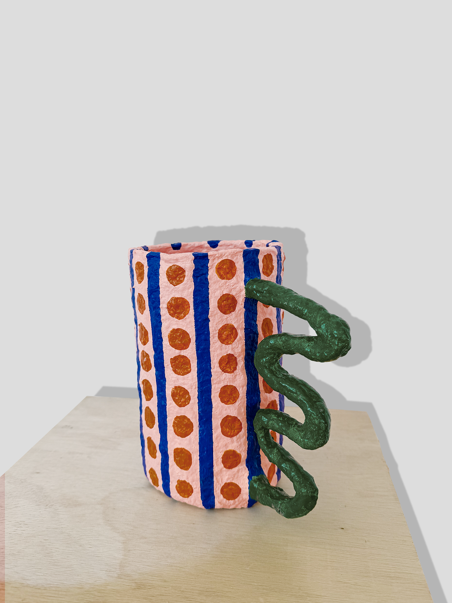 Papier mâché vase with stripes and irregular handle